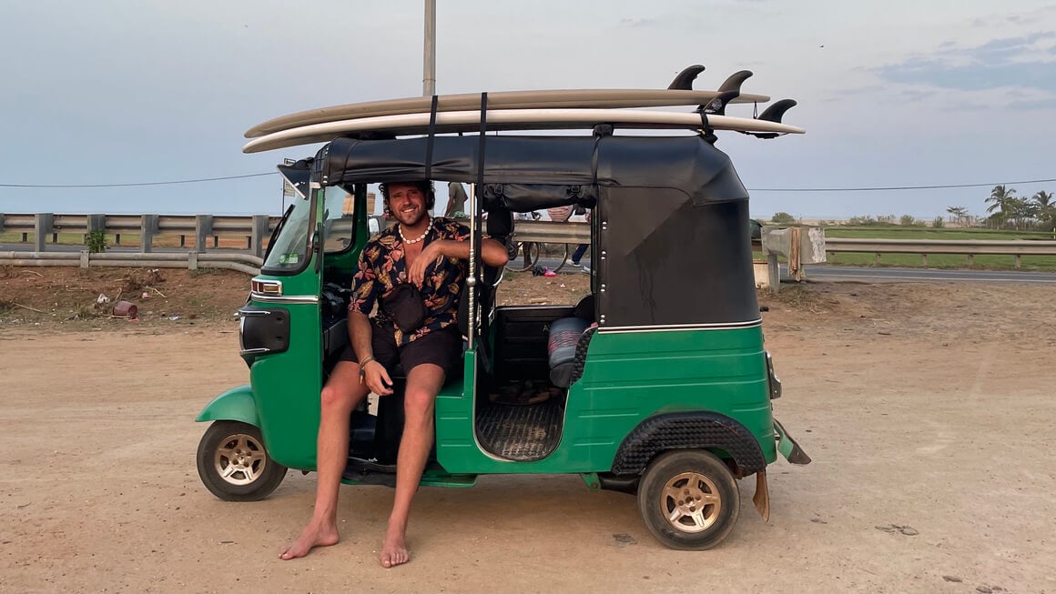 harvey hanging out in a tuktuk with surf boards on the roof in sri lanka