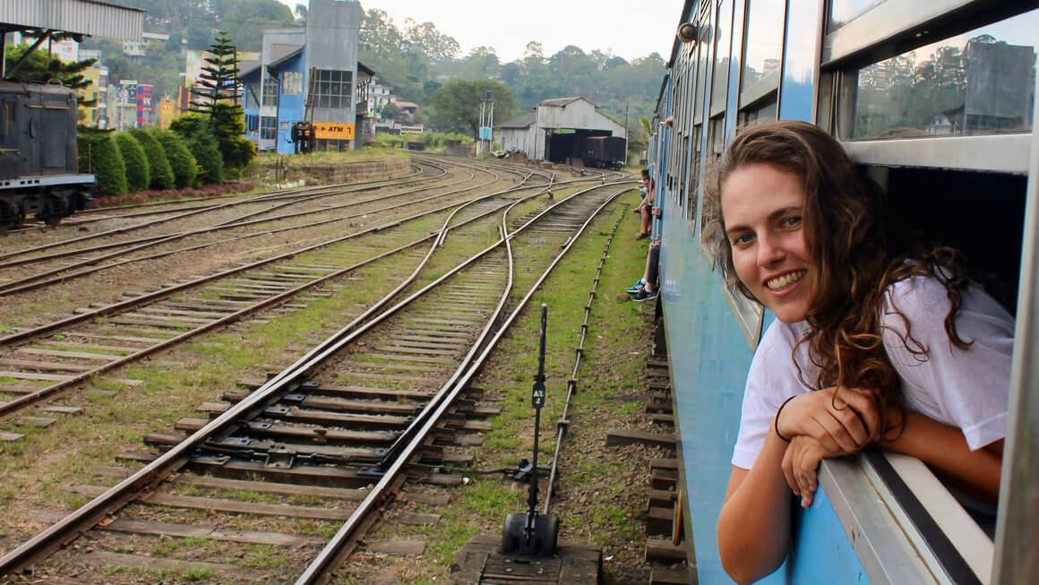 dani hanging out of a train in sri lanka