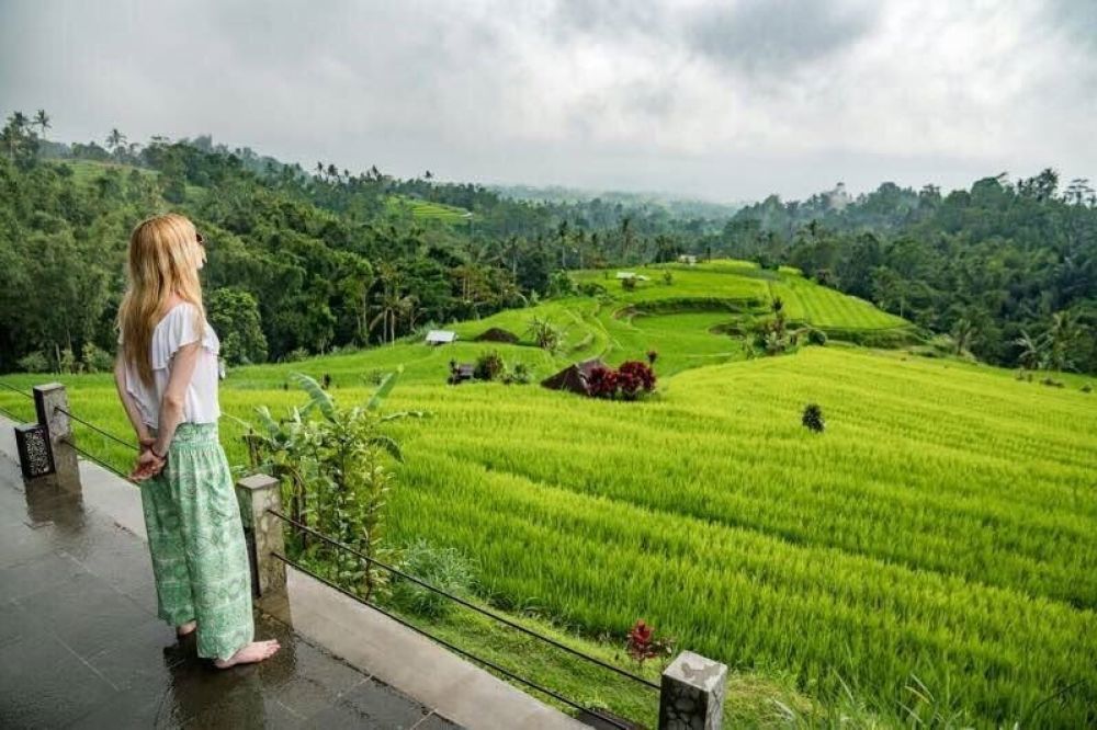 Backpacker watching a rice field in Bali, Indonesia