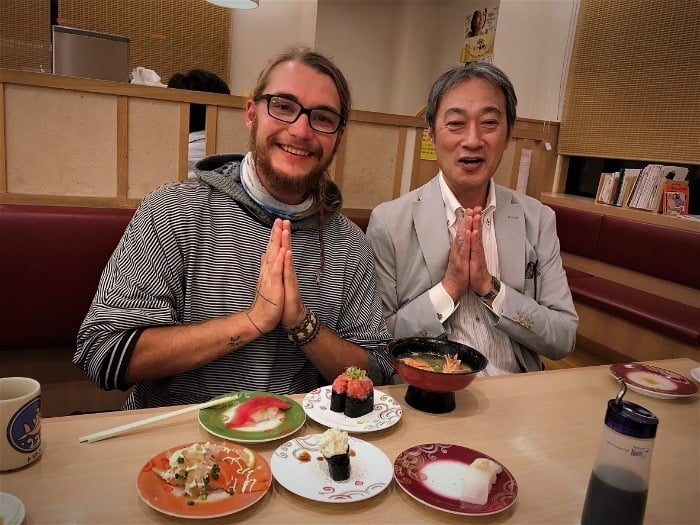 Snacking on food at a sushi restaurant in Osaka