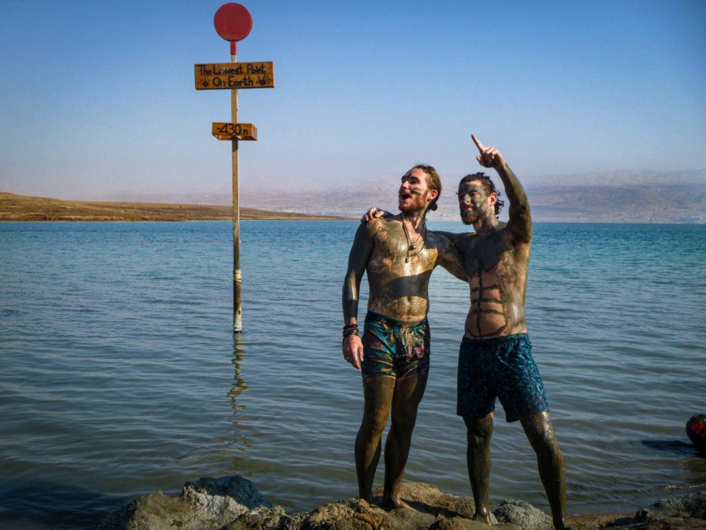 Two backpackers in Israel pose for a photo in the Dead Sea