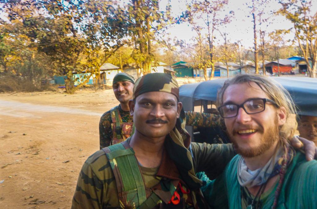 a traveler taking a selfie with two army dudes