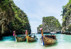 Several longboats moored at a famous beach in Thailand