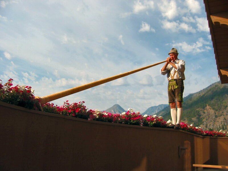 A traditional horn player at a famous European hostel