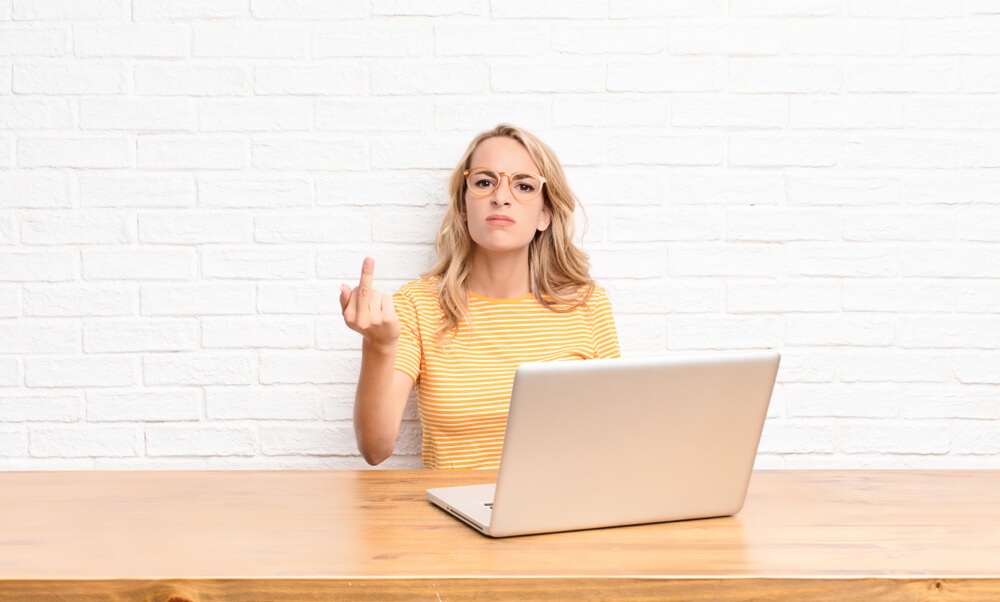 Woman flipping off someone with bad hostel etiquette