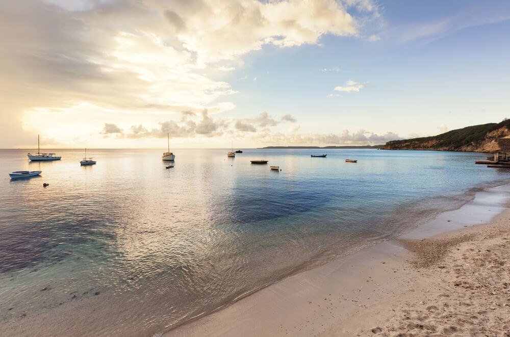 quiet beach in Sint Michiel Curacao with boats floating on the sea