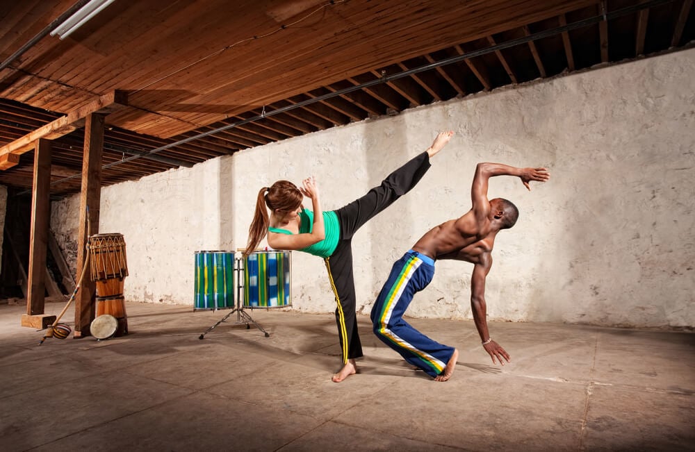 A couple on a honeymoon in Mauritius spar in capoeira