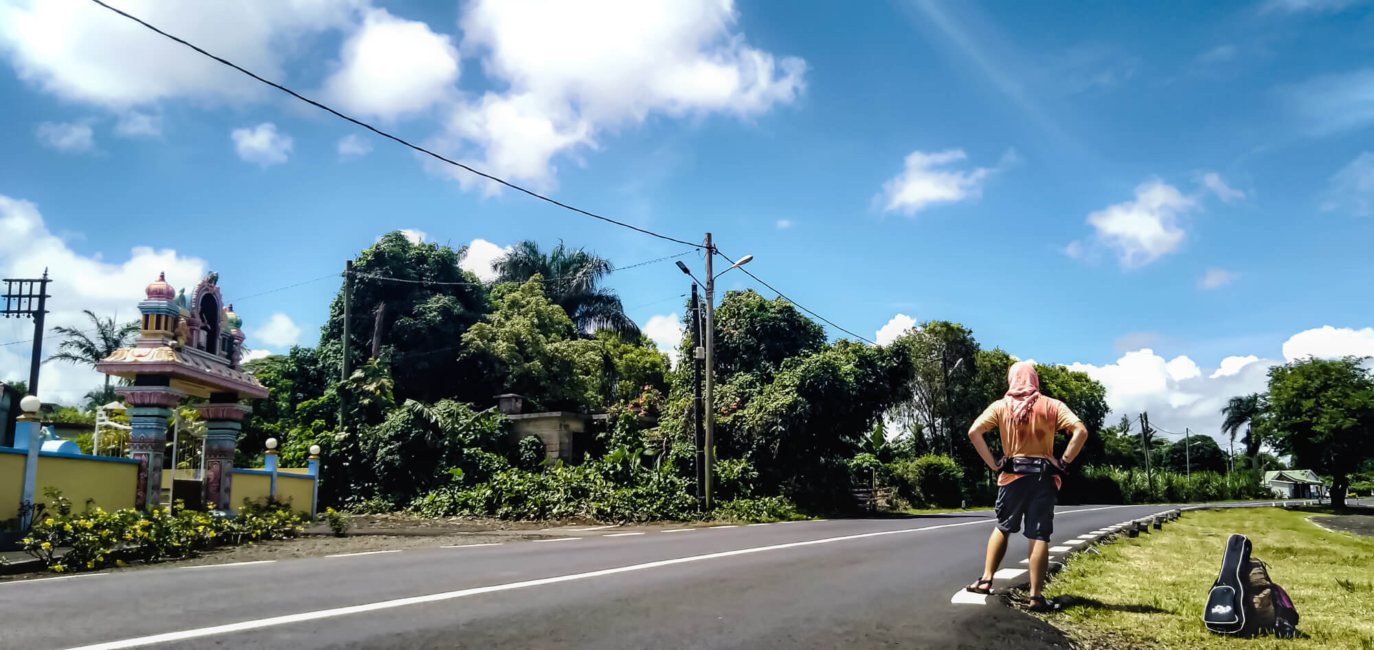 A backpacker hitchhiking in Mauritius to save on travel cost