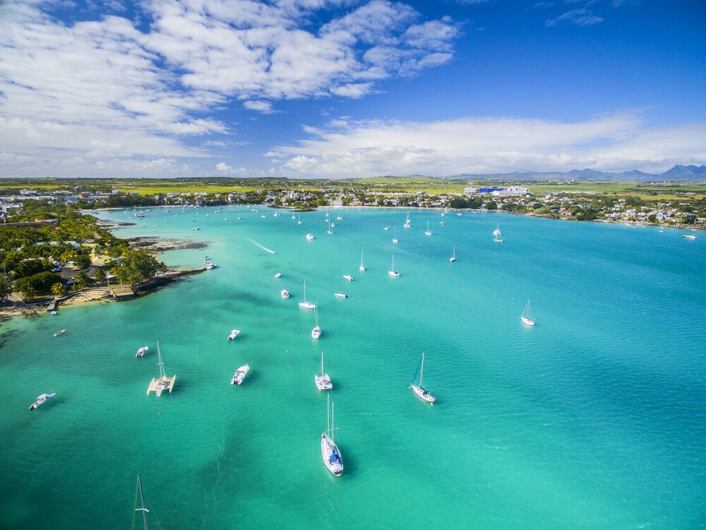 Aerial view of anchored catamarans for tourist cruises in the Grand Baie marina