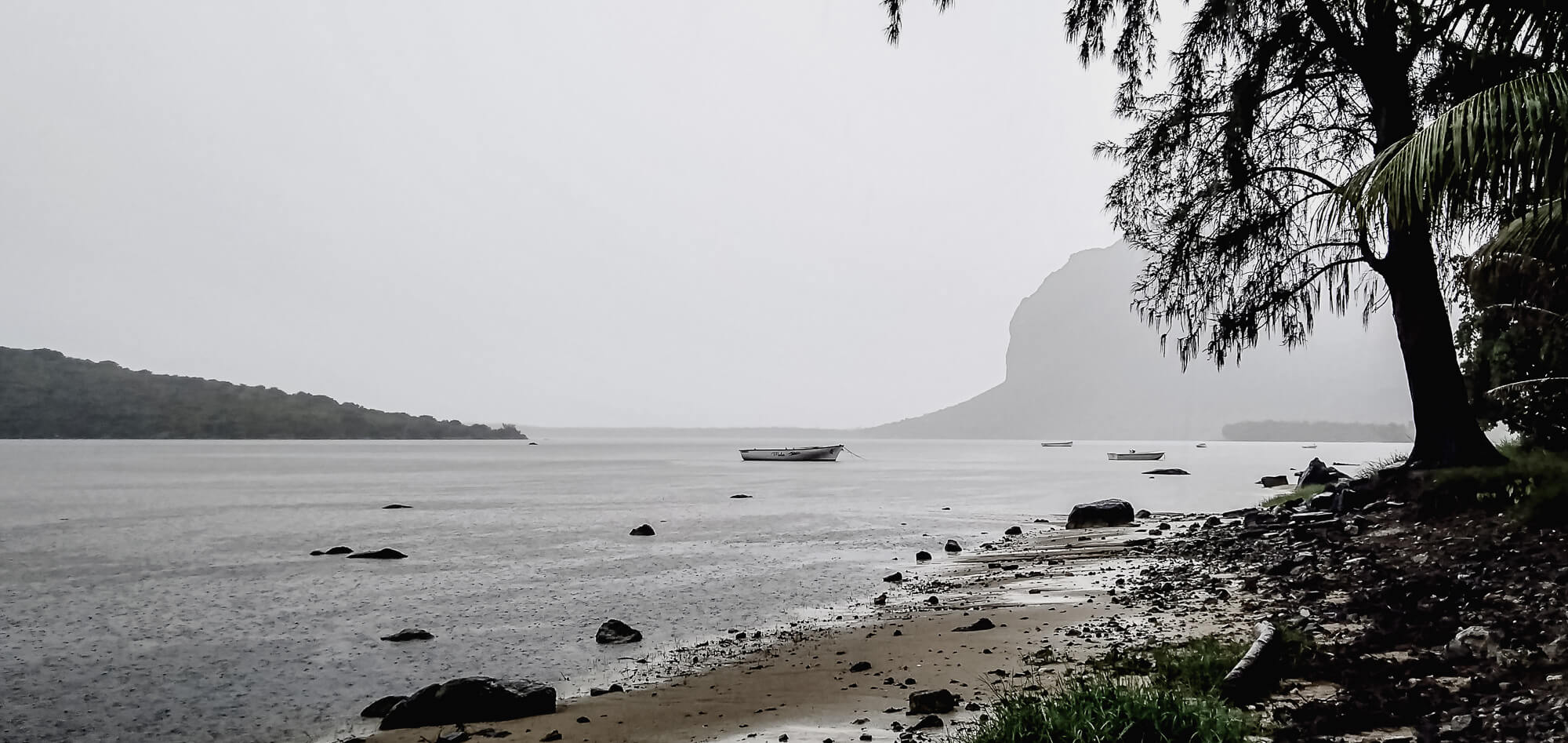 misty beach landscape in le morne, mauritius