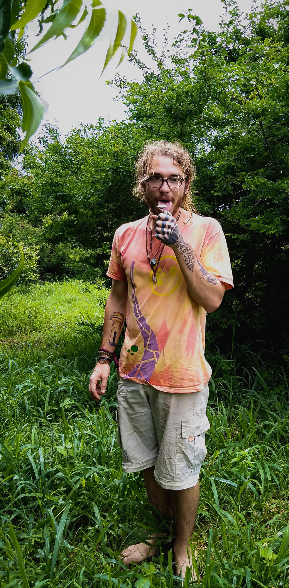 A backpacker enjoying the drug tourism in Africa holds some freshly picked shrooms