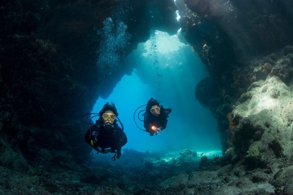 Beginner divers in a cave while taking an Eilat diving course 