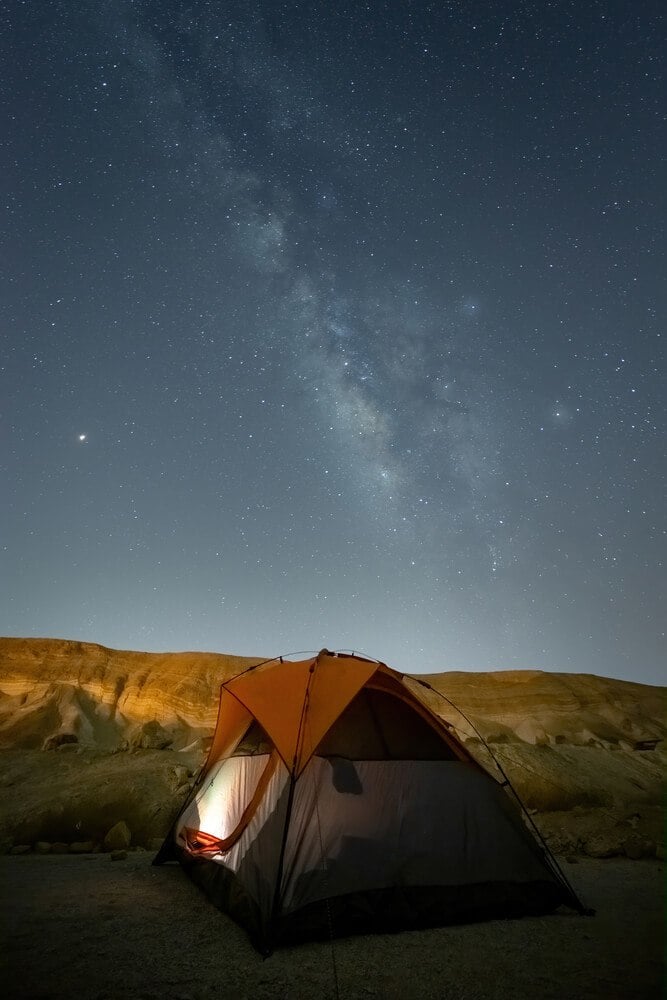 A tent under a starry sky while camping in Israel's southern desert