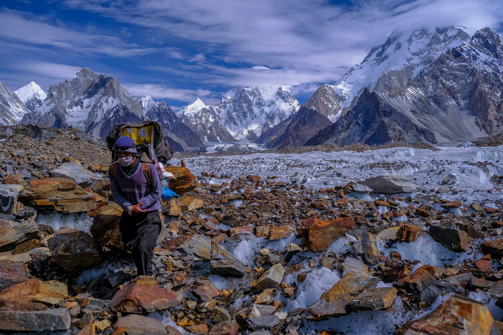 porter carrying bags in the mountains travel to pakistan