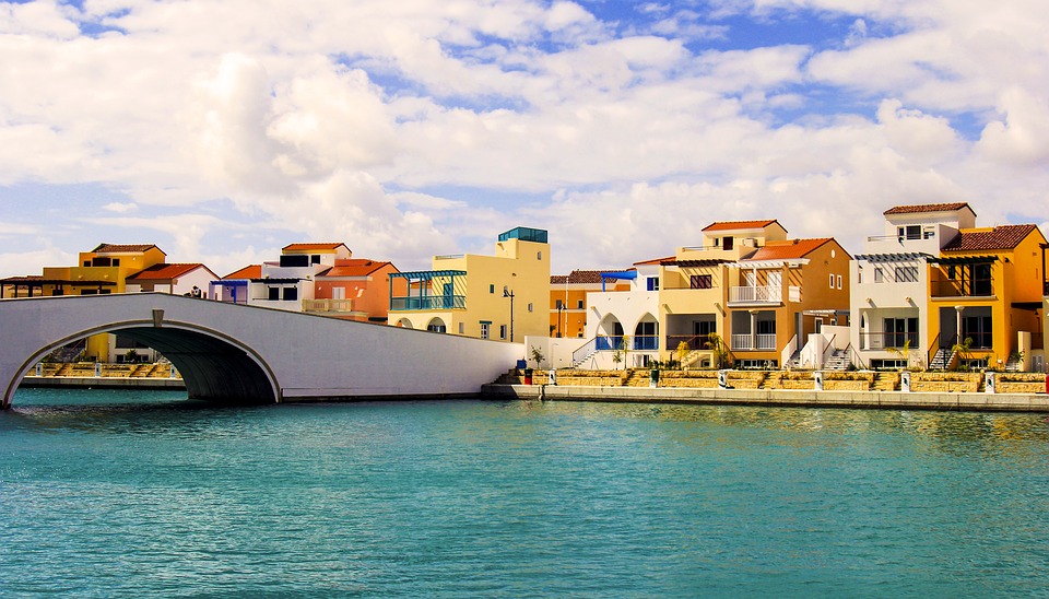 earthy tone homes along the sea in limassol, cyprus on a partly cloudy day
