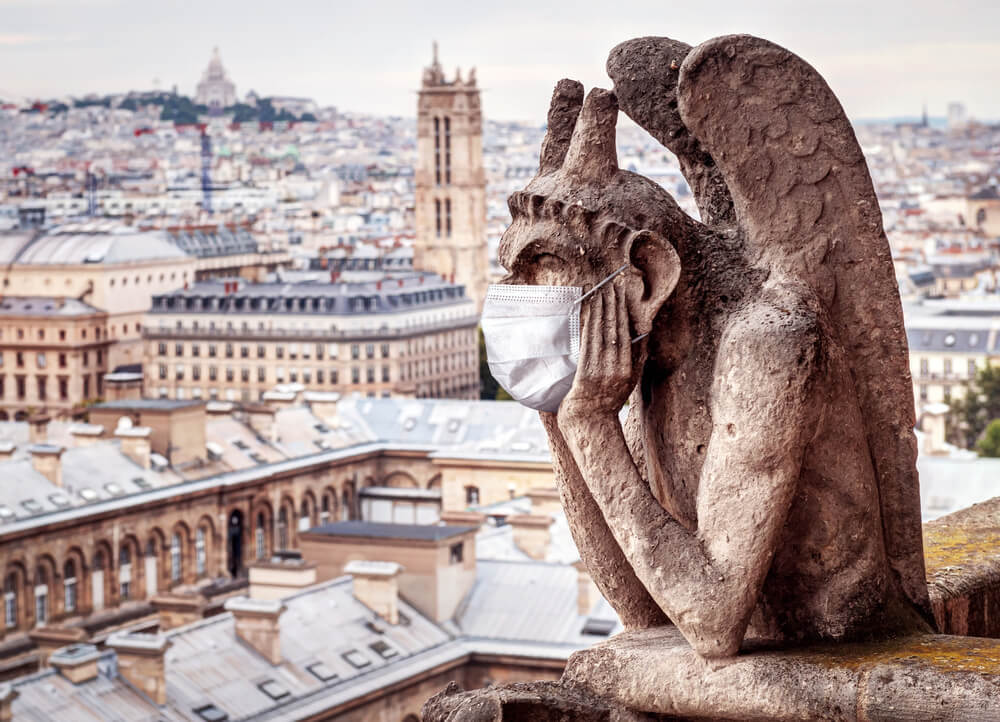 Notre Dame gargoyle with mask after France reopened to tourism