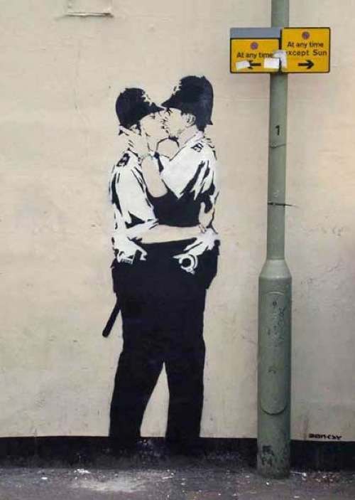 Kissing Coppers Banksy street art while sightseeing in Brighton, the UK