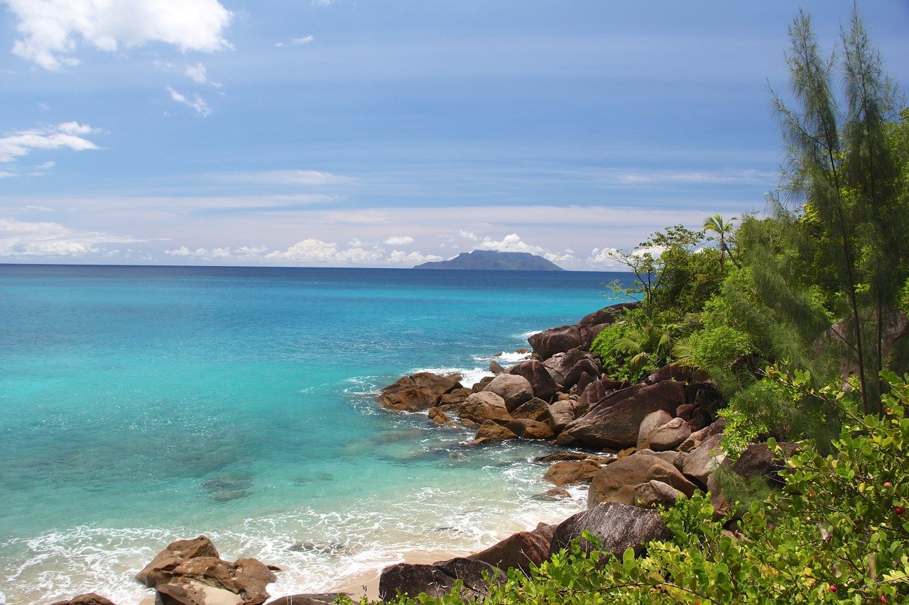 blue green waters and rocky beach seen while staying in Seychelles