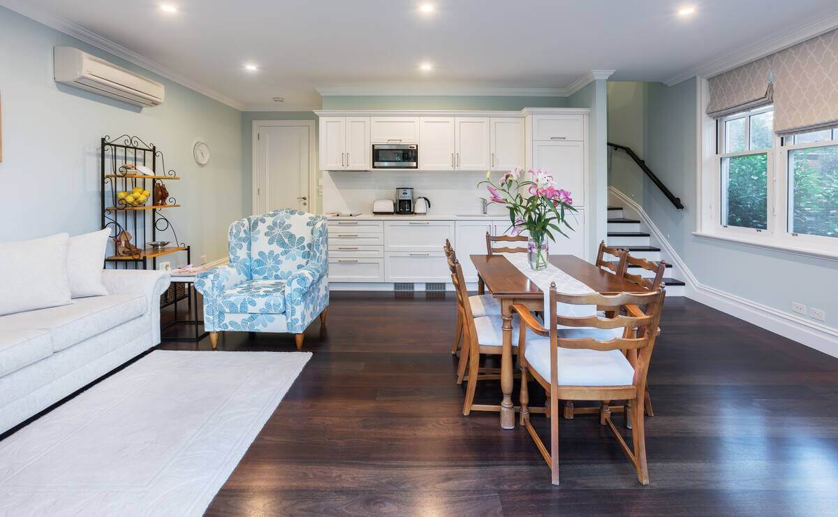 Simple but classic kitchen, dining table and sofas. Blue, white and wooden themed. 