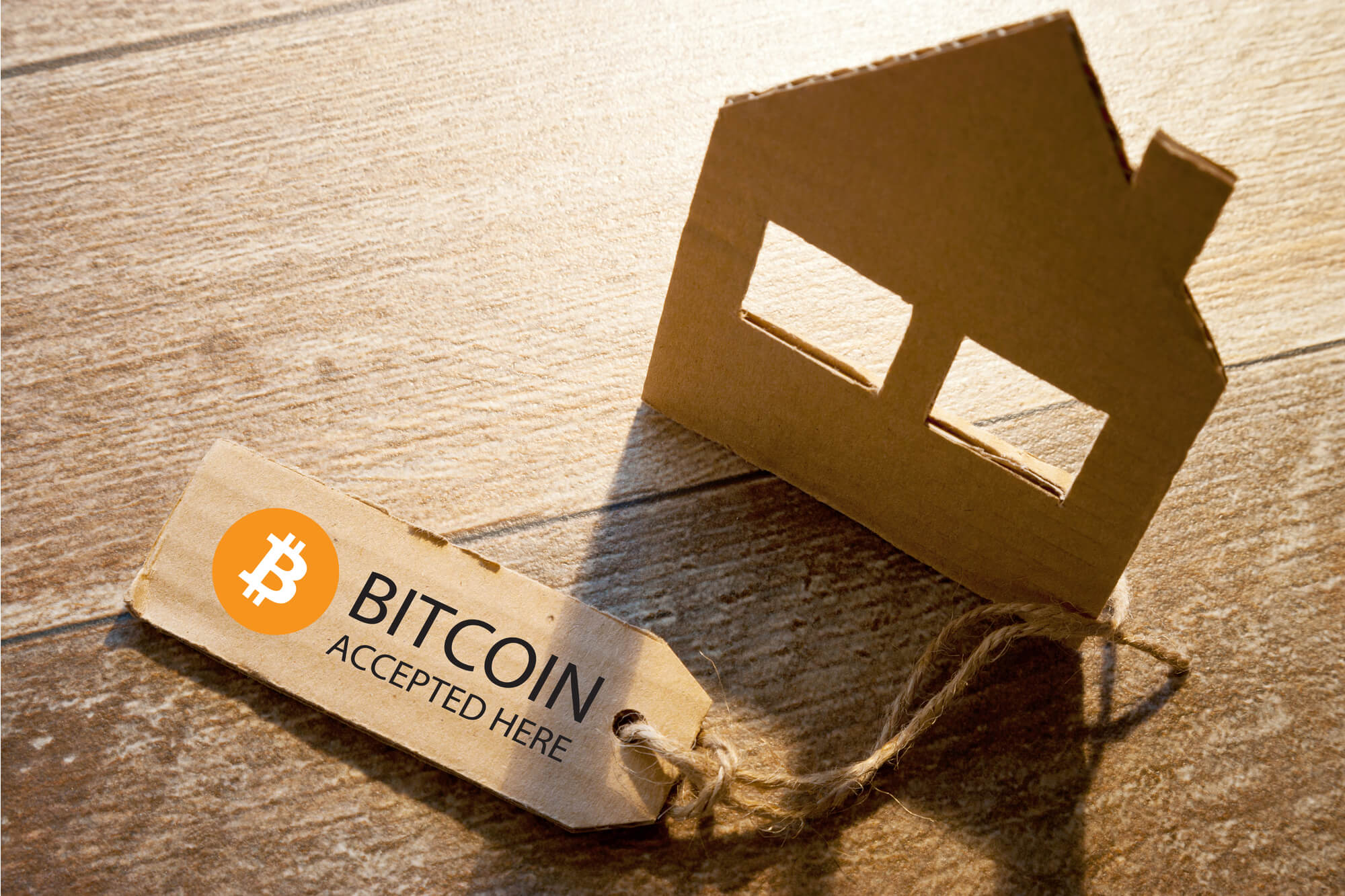 Little cardboard diagram of rental accommodation like Airbnb accepting Bitcoin