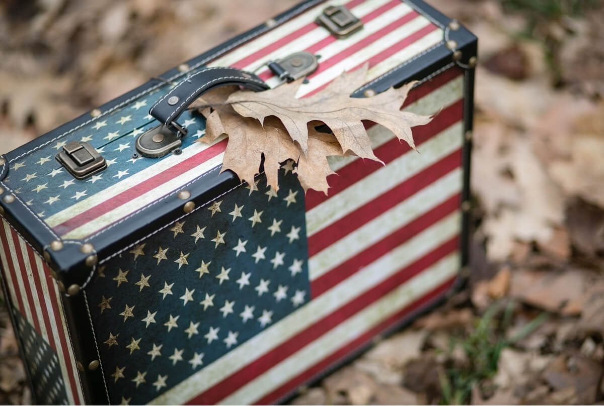 American flag-style suitcase packed for a country that is accepting US citizens