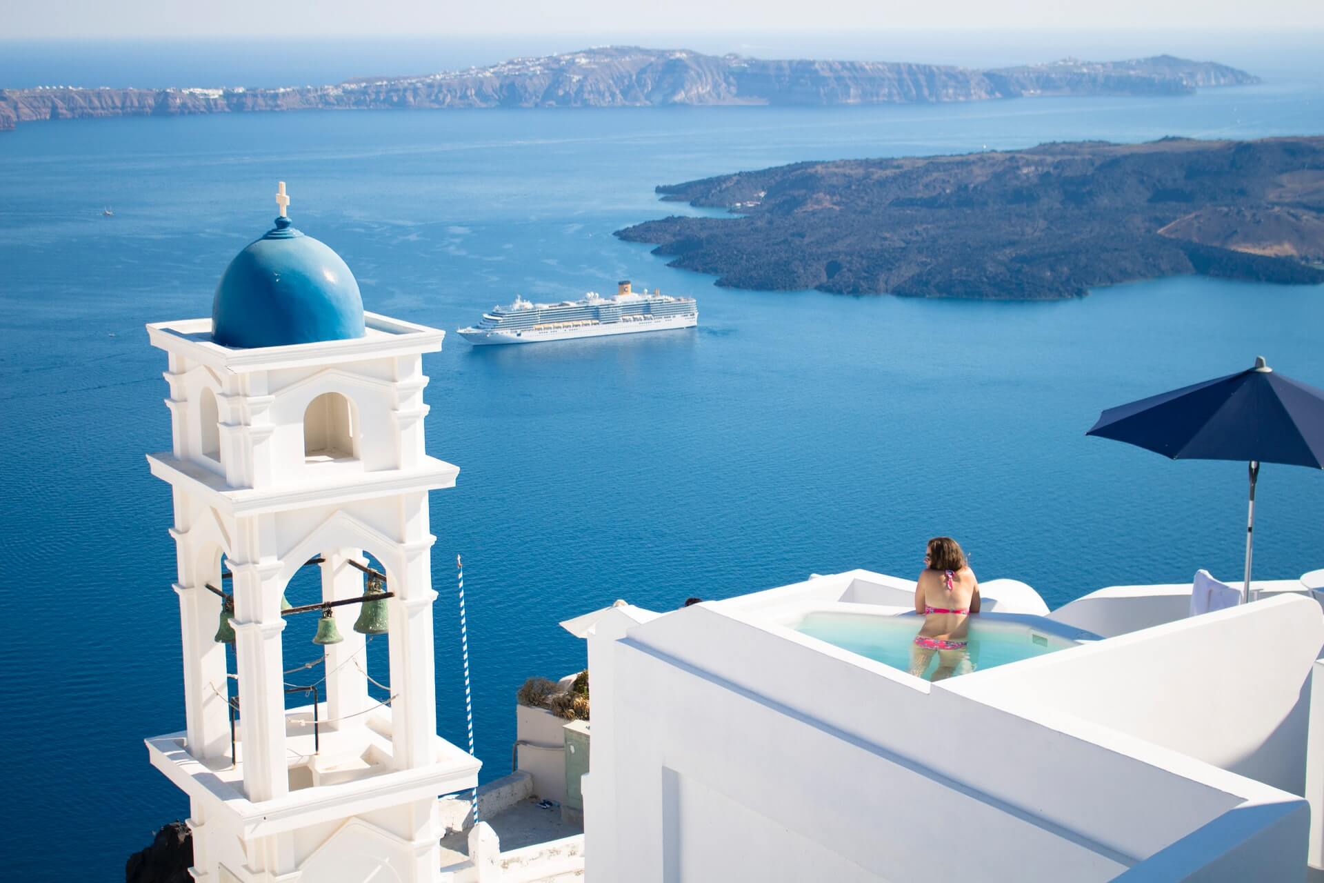 A tourist in Oia, Santorini, enjoying the pool at her accommodation