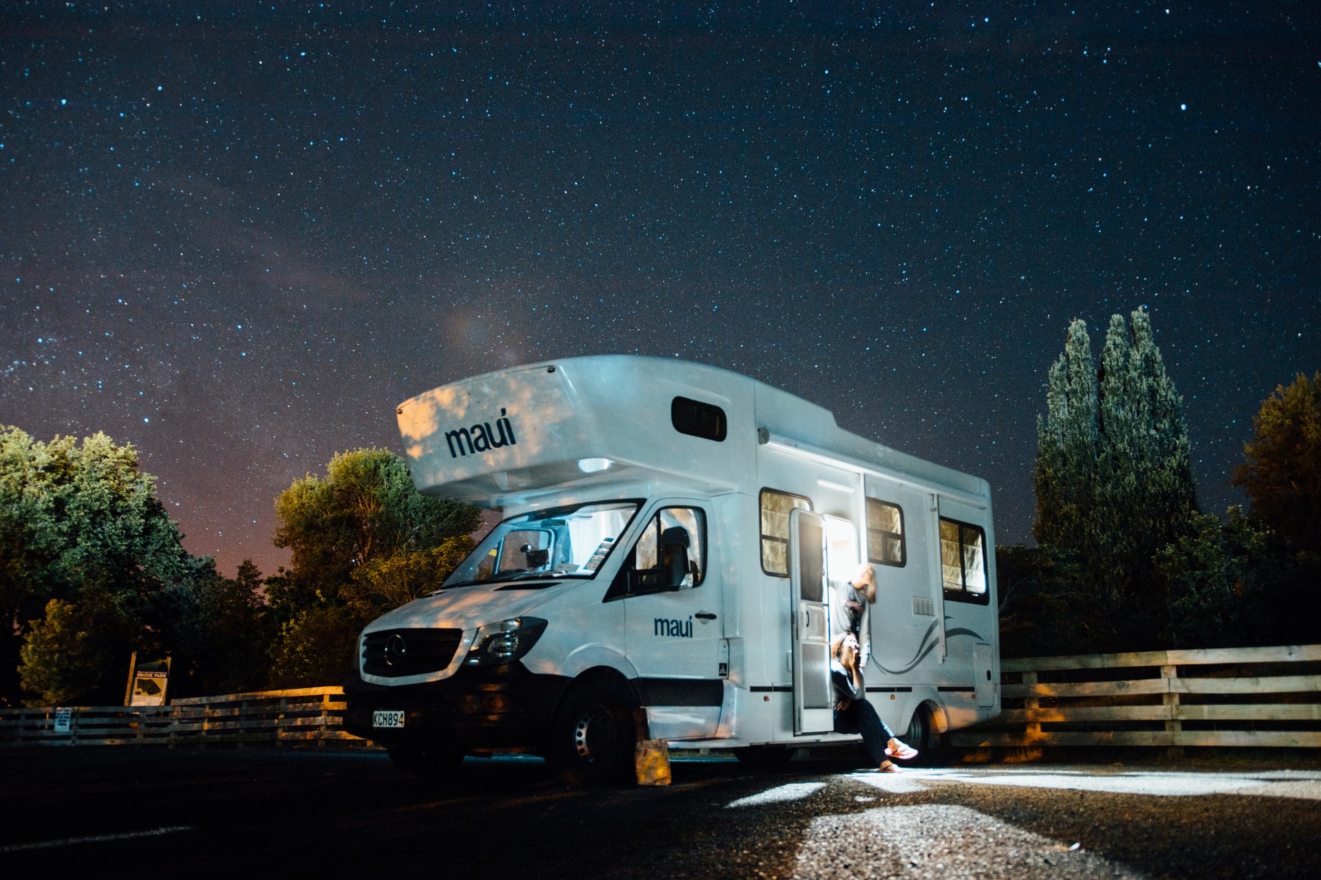 Two people planning tomorrow's RV trip while parked overnight