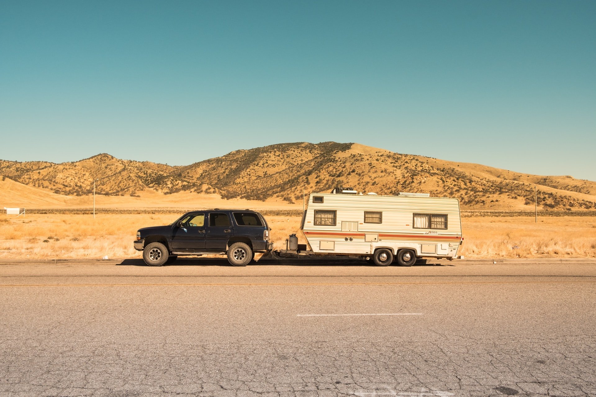 A camping trailer parked in a desert after burning through their RV trip budget