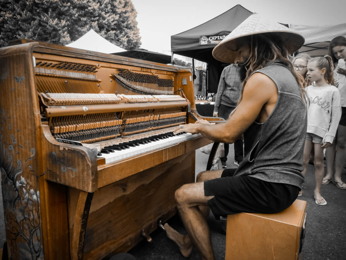 Busker at the markets in Motueka seen while driving through the north of South Island