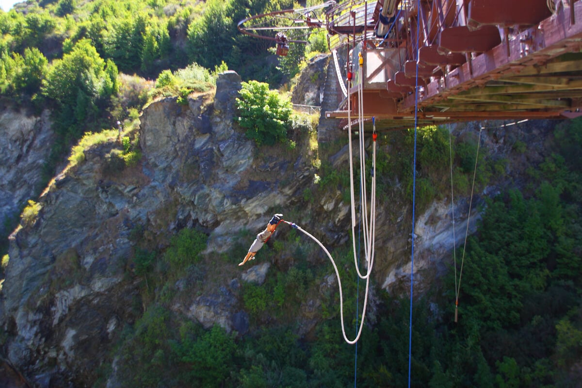 A backpacker in Queenstown does a bungy jump from Kawarau Bridge