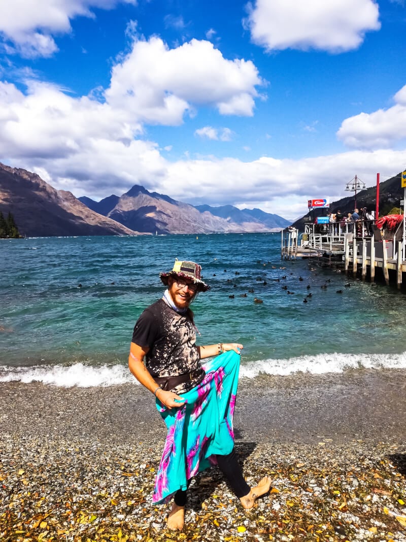 A budget backpacer in Queenstown shows off his second-hand shopping score at the waterfront