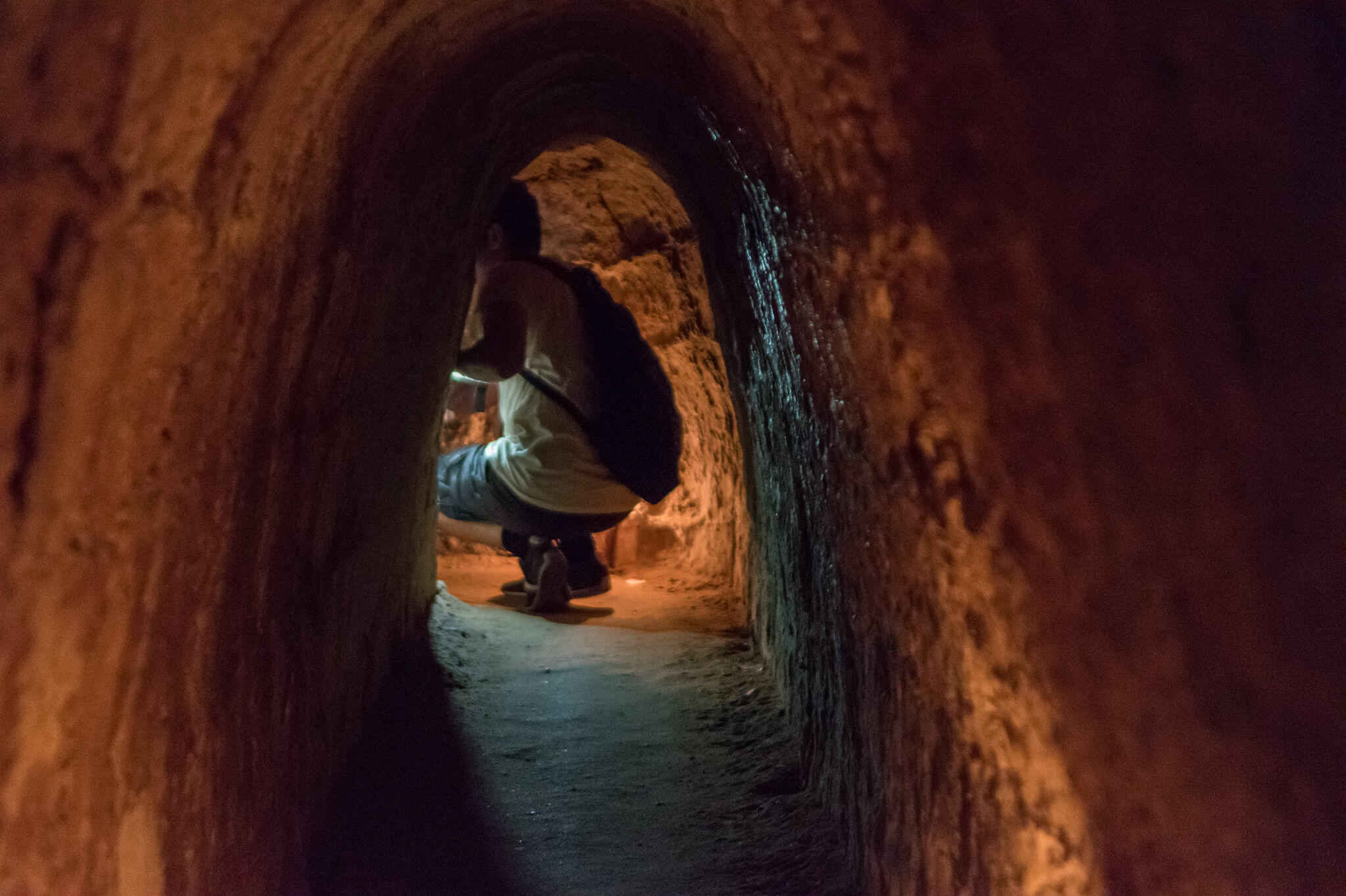 A tourist on a tour of a Cu CHi Tunnel