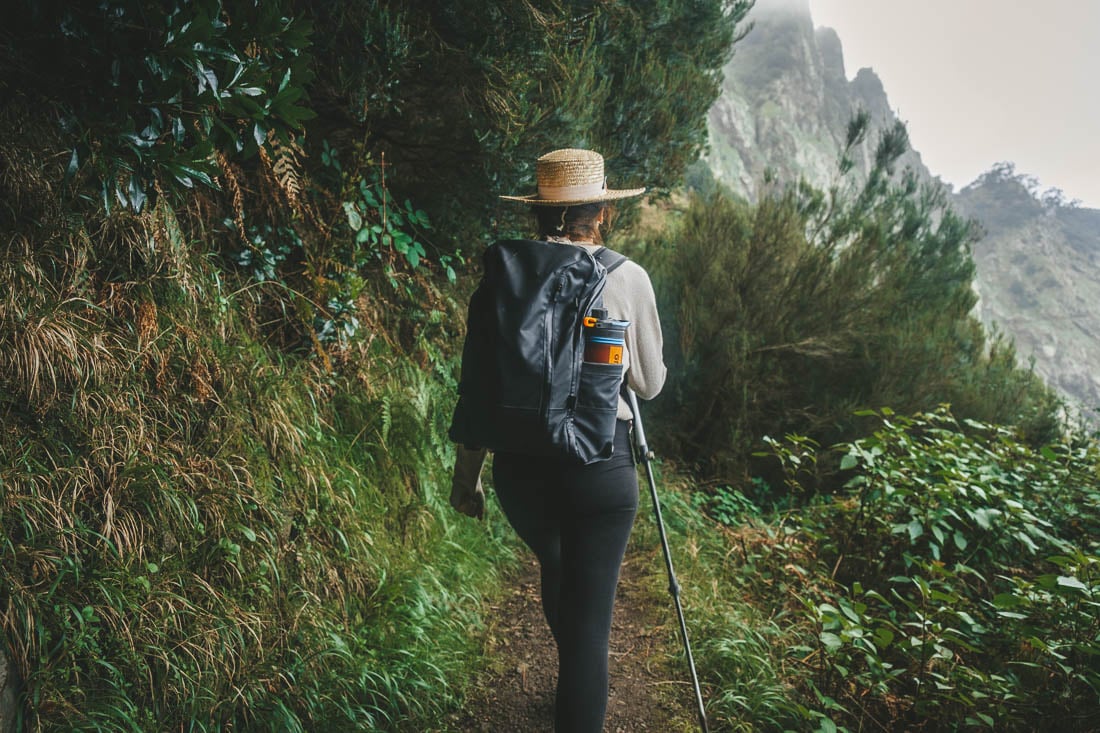 Lady hiking in Maderia, Portugal with hiking pole