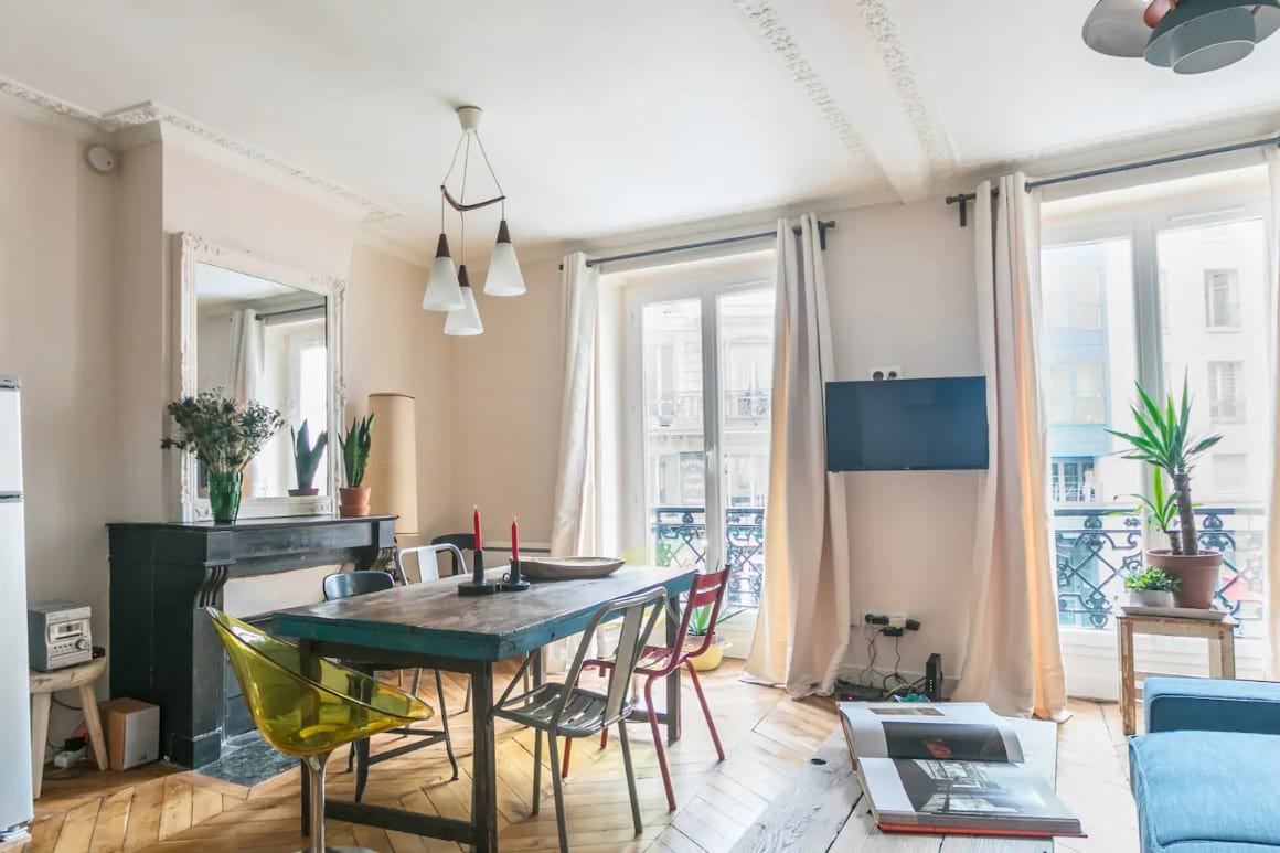 Bright living room with large dining table and floor to ceiling windows