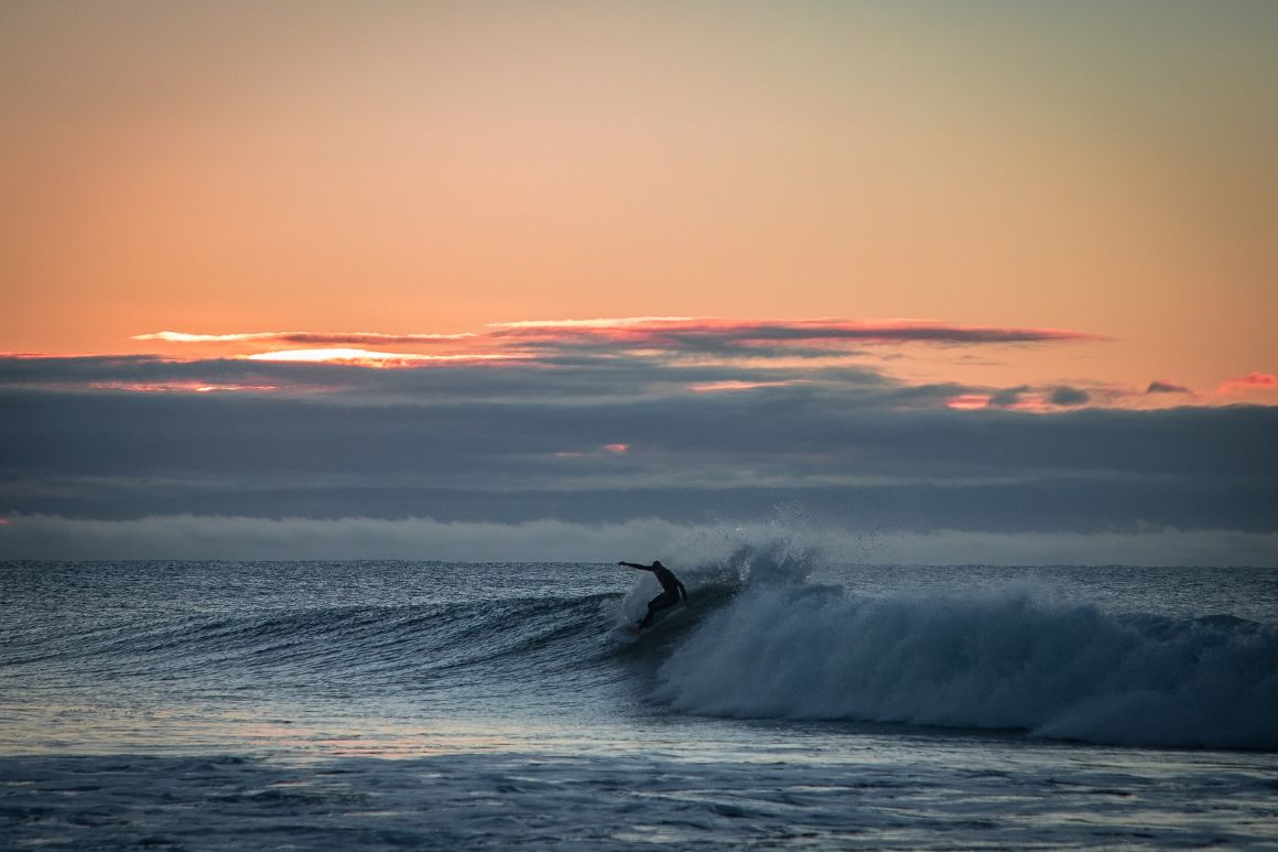 Surfer in melbourne at sunset.