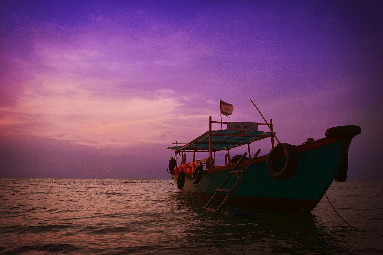 is cambodia safe traditional boat floating at sunset