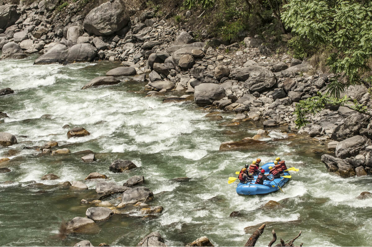 Tour group does whitewater rafting as an adventure activity in Nepal