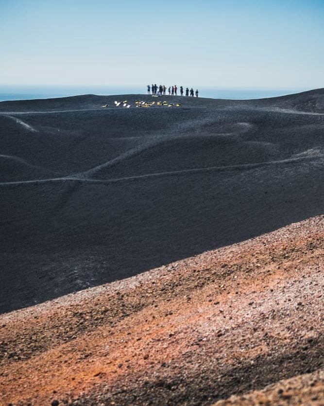 group of hikers climbing volcano