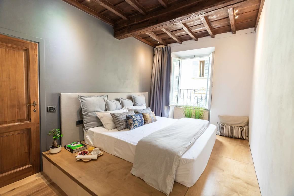 Simple bedroom in airbnb. Comfy bed on an elevated floor. Lots of light coming in from the window