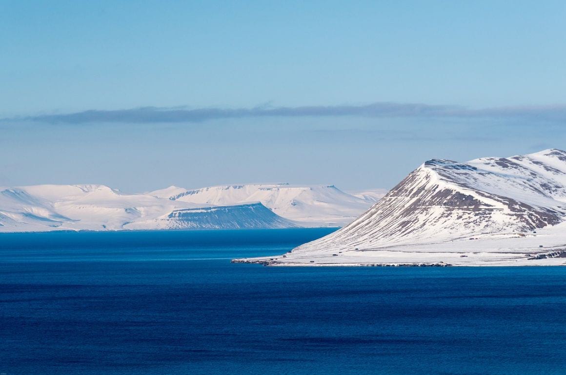 view of glaciers covered in snow on the sea in svalbard norway