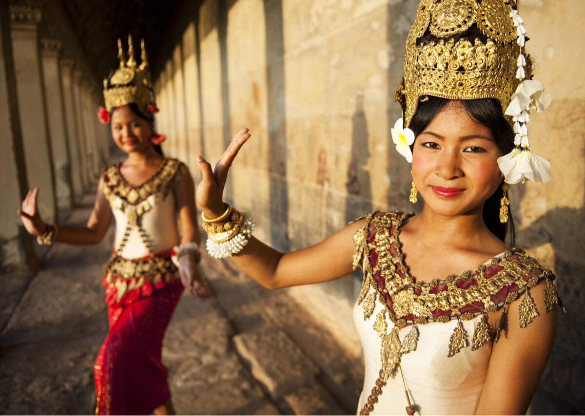 Two beautiful Cambodian women wearing traditional dress outfits.