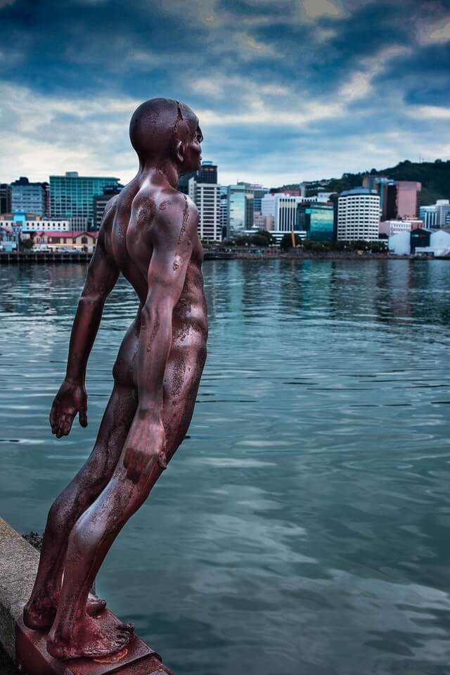 The leaning man 'Solace in the Wind' statue at the waterfront of Wellington harbour