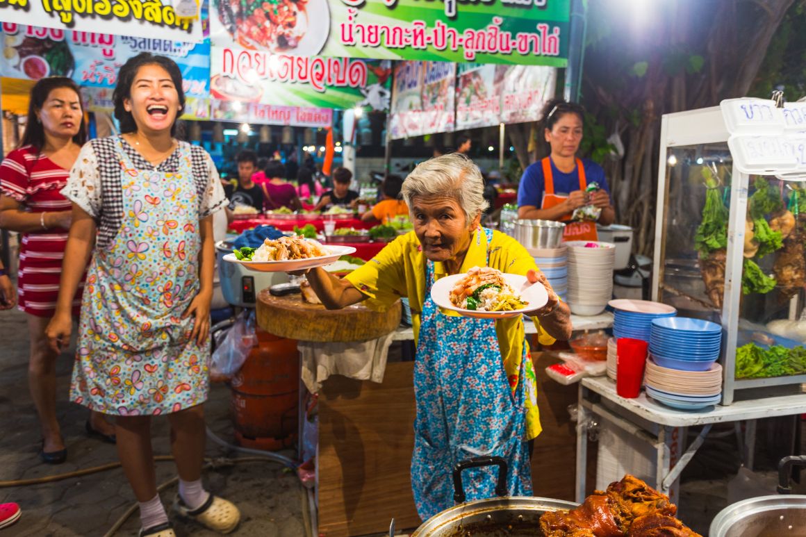 old lady serving street food in Thailand