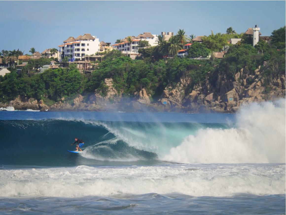 A surfer riding the huge waves of Playa Zicatela, Puerto Escondido.