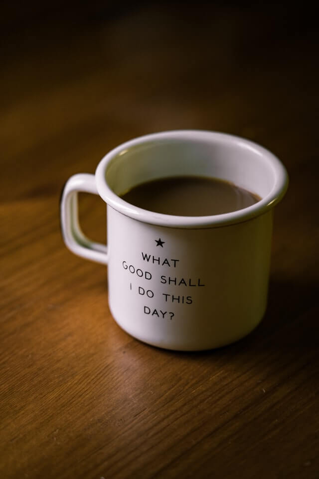 A mug of coffee with a pondering emblazoned on the side.