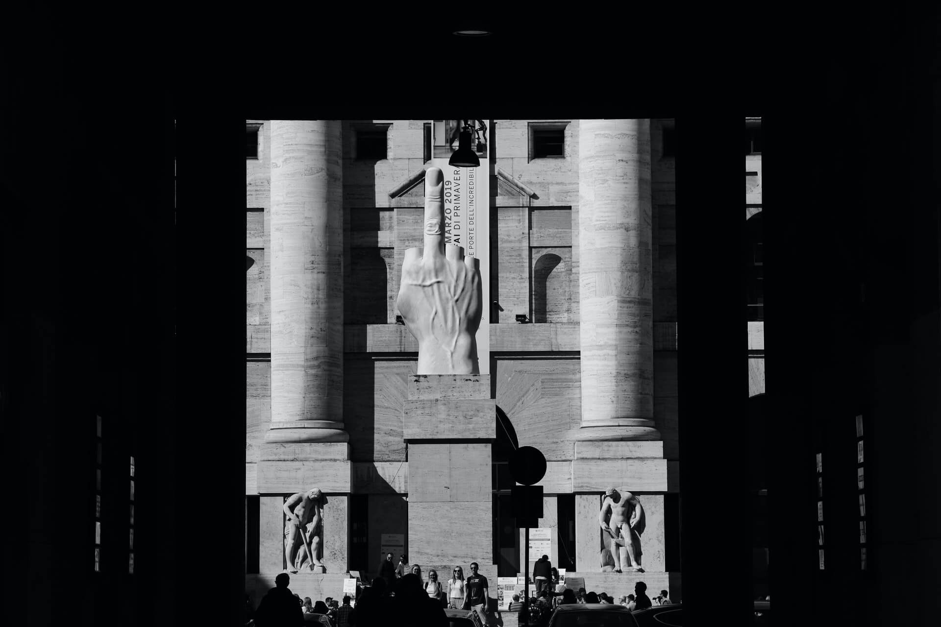 A statue of a middle finger salute in Milan, Italy