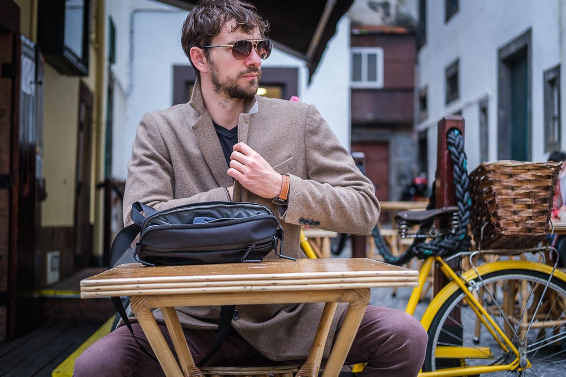 black sling bag at a cafe