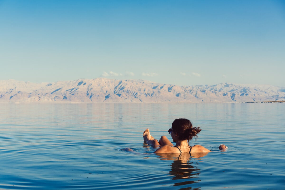 A solo female traveller relaxing in the Dead Sea - a classic tourist activitiy in Israel