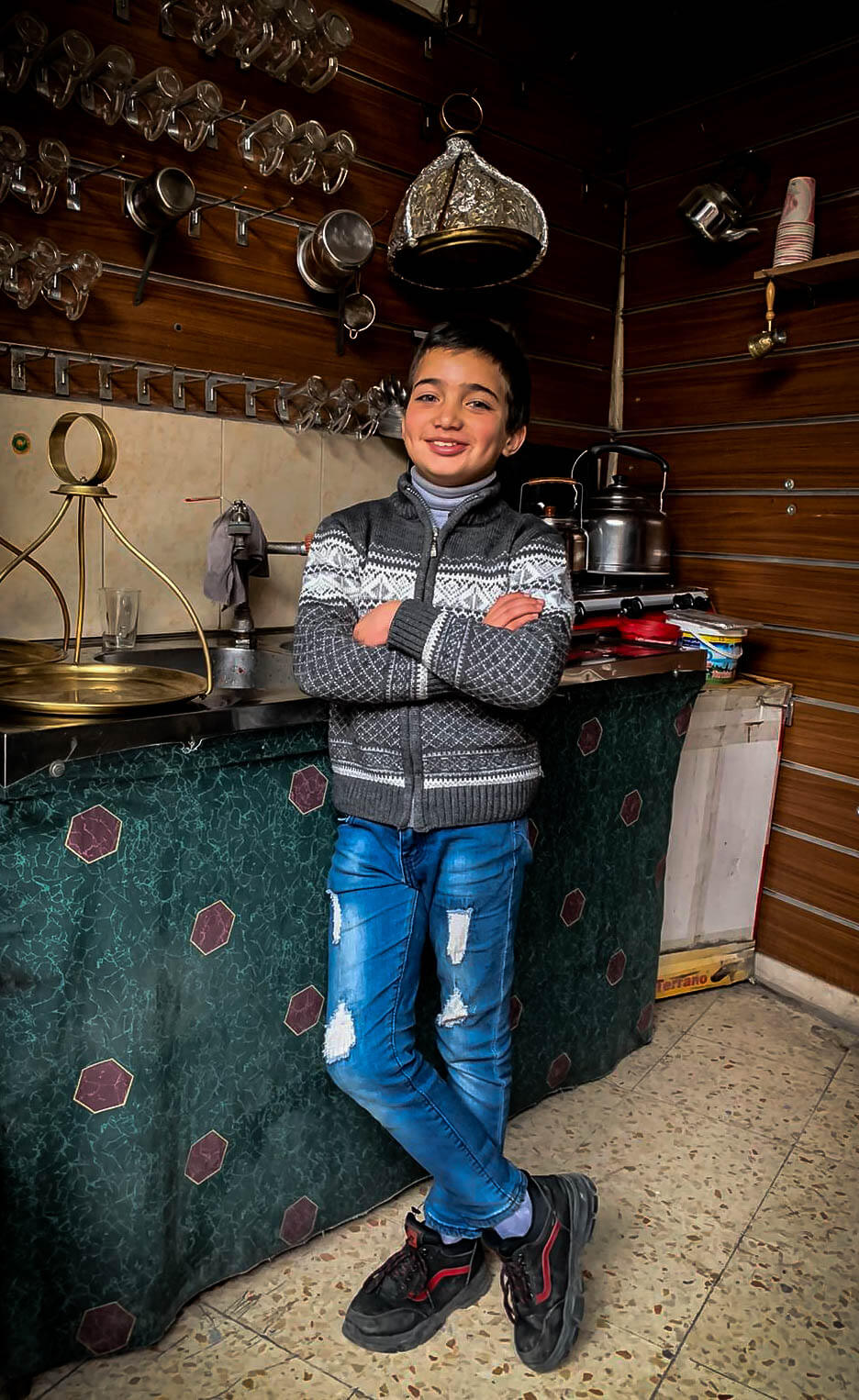 A Palestinian kid poses for a photo for a backpacker in Hebron