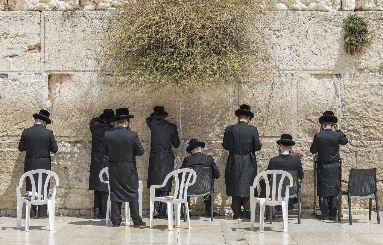 Orthodox Jews at a wall in Israel. 